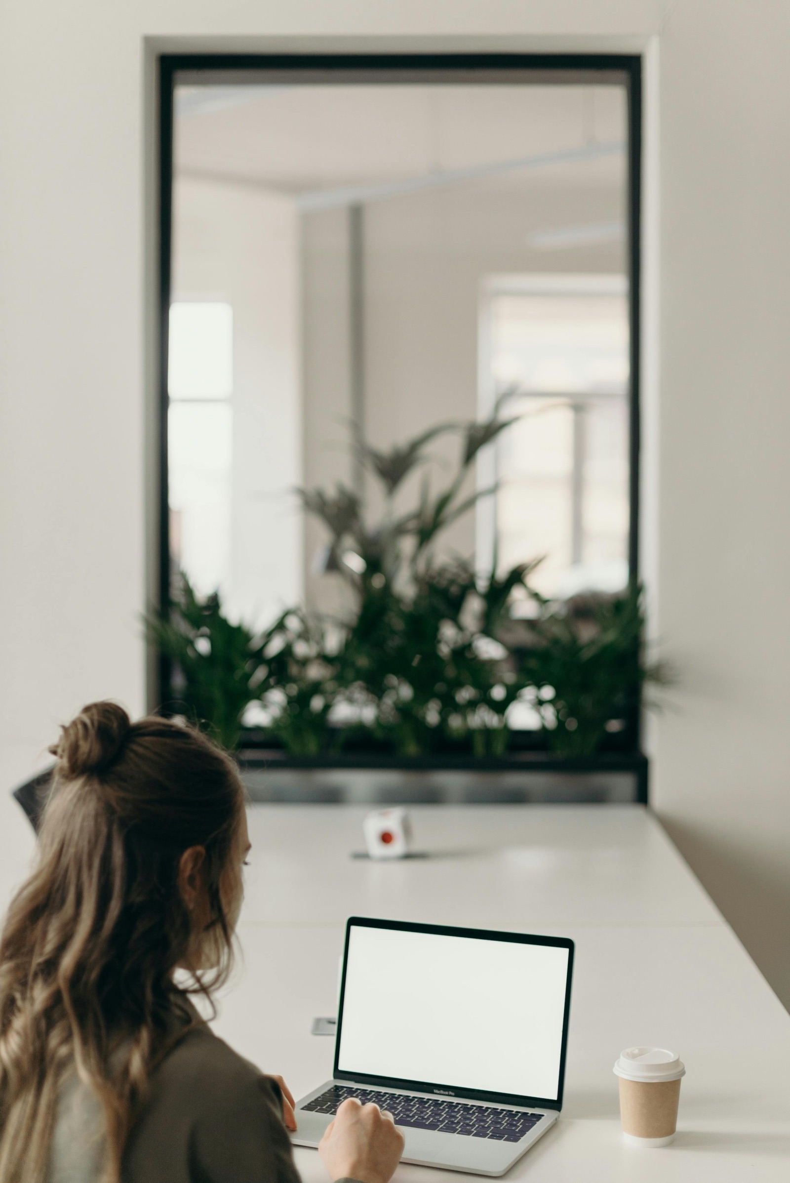 Product manager reviewing a product roadmap on a laptop at a wooden desk